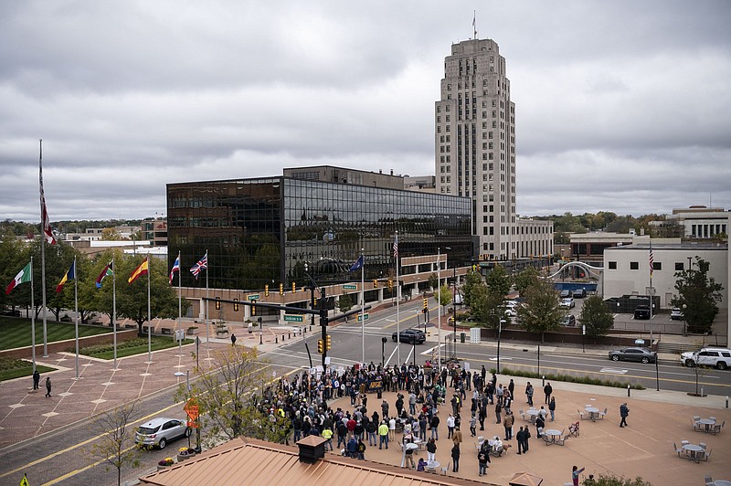 FILE - Union members and supporters gather during a rally outside Kellogg's World Headquarters on Oct. 27, 2021, to support workers on strike in Battle Creek, Mich. Kellogg?s plans to start hiring permanent replacements for some of its 1,400 striking cereal plant workers after negotiations broke down again. The company said it failed to reach an agreement with the Bakery, Confectionery, Tobacco Workers and Grain Millers International Union Monday, Nov. 22, 2021 so it is moving forward with its contingency plan to keep its plants operating. (Alyssa Keown/Battle Creek Enquirer via AP)