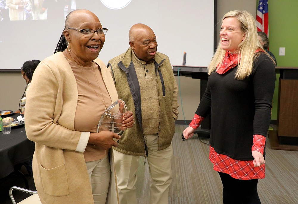 Marilyn Suber, left, reacts as she and her husband, Hiller, are named the 2021 Foster Parents of the Year. Mischa Martin, right, director of the Arkansas Department of Human Services’ Division of Children and Family Services, said the Subers were recognized for their support of teens in foster care. (Special to The Commercial/Arkansas Department of Human Services)