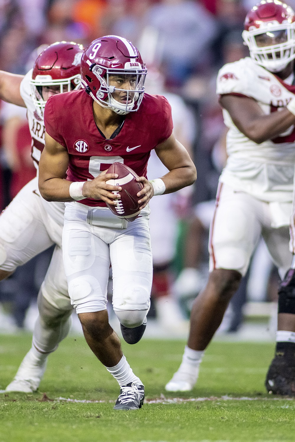 Alabama quarterback Bryce Young (9) scrambles against Arkansas during the second half of an NCAA college football game, Saturday, Nov. 20, 2021, in Tuscaloosa, Ala. (AP Photo/Vasha Hunt)