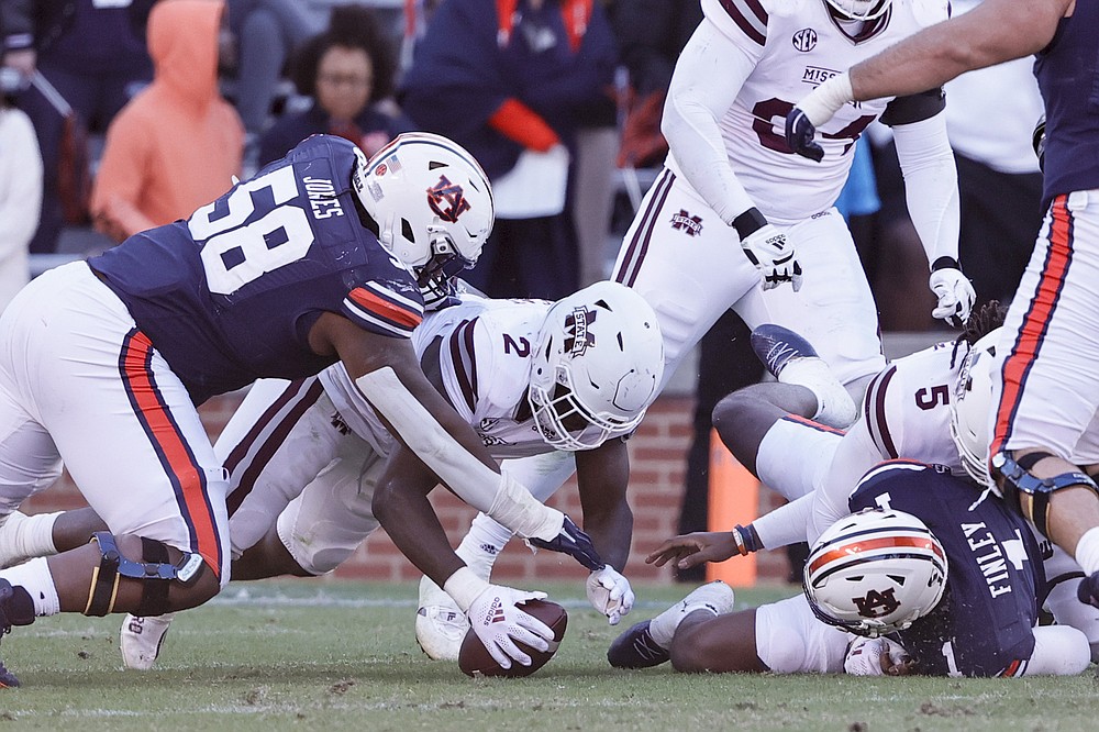 Mississippi State linebacker Tyrus Wheat (2) recovers a fumble by Auburn quarterback TJ Finley (1) during the second half of an NCAA college football game Saturday, Nov. 13, 2021, in Auburn, Ala. (AP Photo/Butch Dill)
