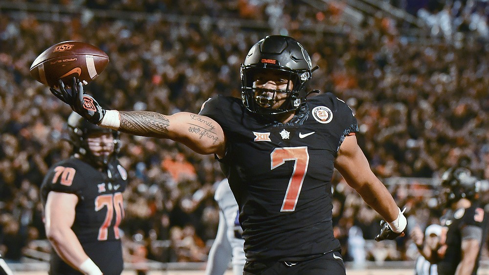 Oklahoma State running back Jaylen Warren (7) celebrates following his touchdown during the first half of the team's NCAA college football game against TCU on Saturday, Nov. 13, 2021, in Stillwater, Okla. (AP Photo/Brody Schmidt)