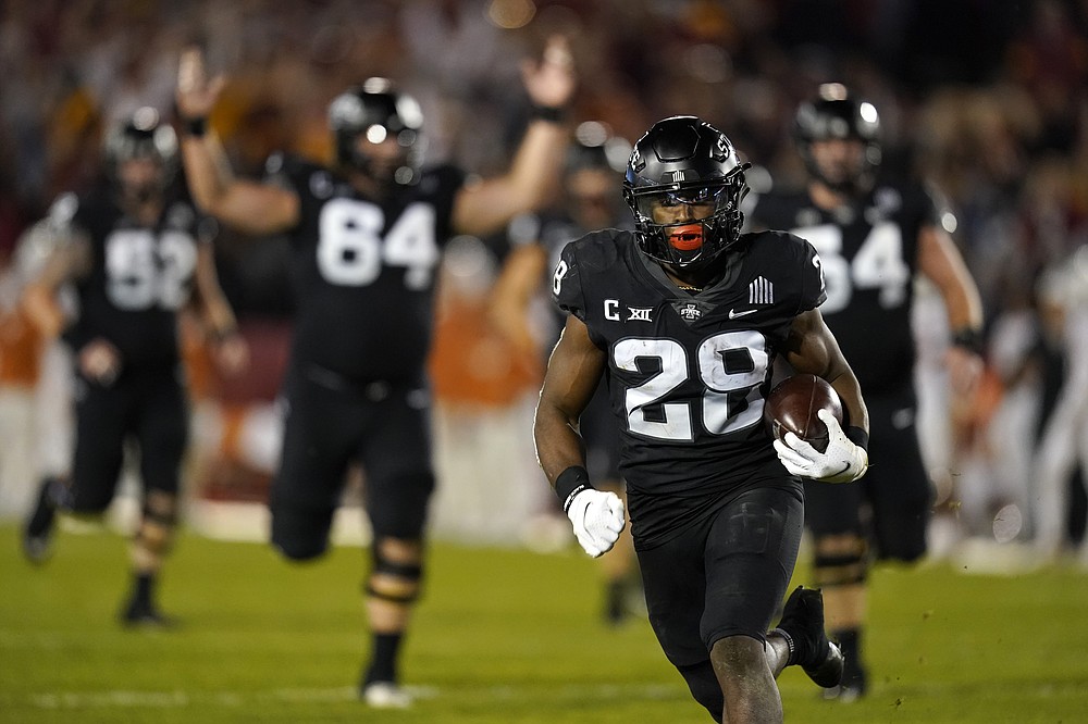 Iowa State running back Breece Hall (28) scores on a 47-yard touchdown run during the second half of an NCAA college football game against Texas, Saturday, Nov. 6, 2021, in Ames, Iowa. Iowa State won 30-7. (AP Photo/Charlie Neibergall)