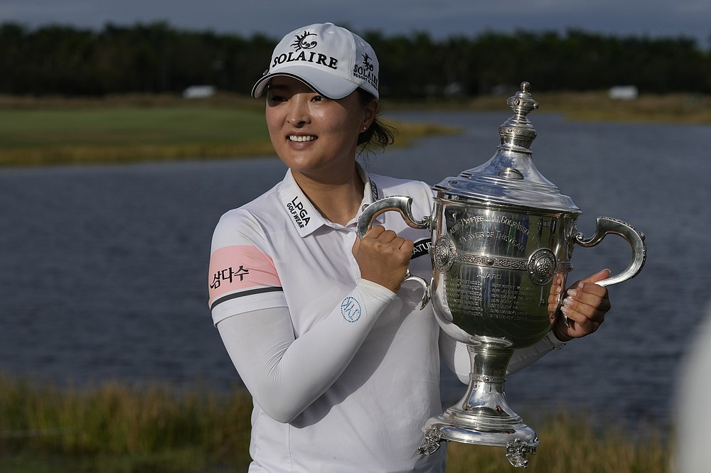 Jin Young Ko, of Korea, holds the player of the year trophy after winning the LPGA Tour Championship golf tournament, Sunday, Nov. 21, 2021, in Naples, Fla. (AP Photo/Rebecca Blackwell)
