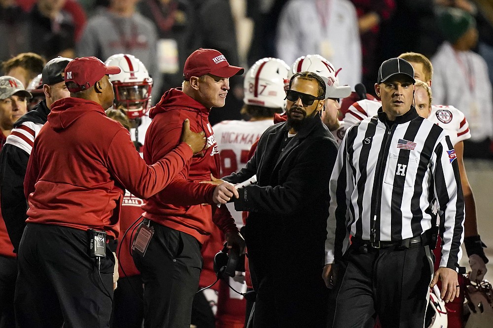 Nebraska coach Scott Frost is restrained while arguing a call during the second half of the team's NCAA college football game against Wisconsin on Saturday, Nov. 20, 2021, in Madison, Wis. (AP Photo/Andy Manis)