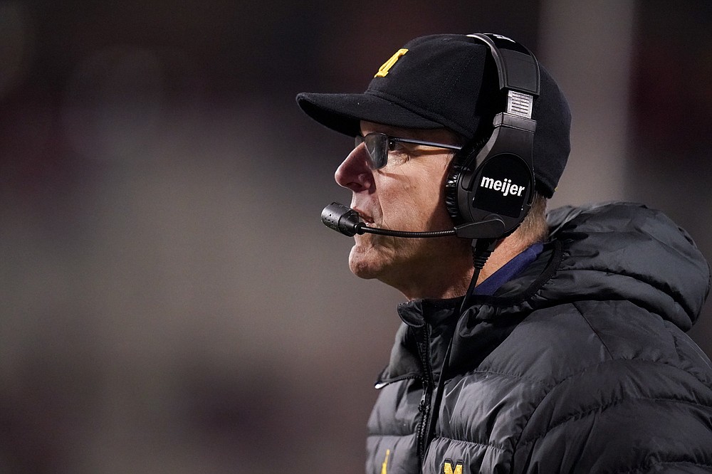 Michigan head coach Jim Harbaugh looks on during the first half of an NCAA college football game against Maryland, Saturday, Nov. 20, 2021, in College Park, Md. Michigan won 59-18. (AP Photo/Julio Cortez)