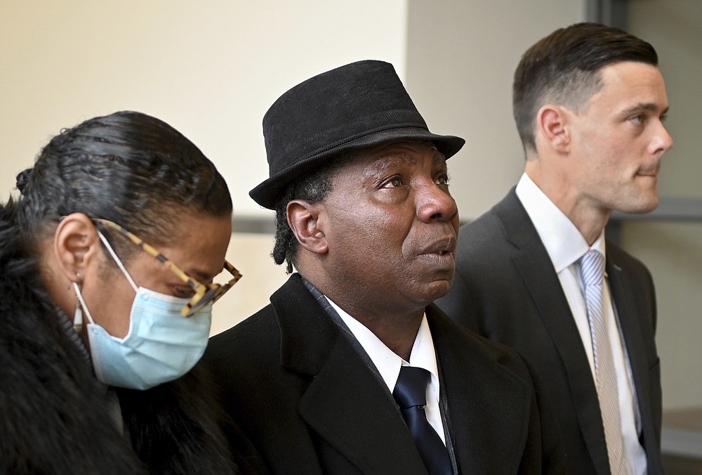 Anthony Broadwater, center, gazes upward, Monday, Nov. 22, 2021, in Syracuse, N.Y., after Judge Gordon Cuffy overturned the 40-year-old rape conviction that wrongfully put him in state prison for Alice Sebold's rape. Broadwater, who spent 16 years in prison, was cleared Monday by a judge of raping Sebold when she was a student at Syracuse University, an assault she wrote about in her 1999 memoir, "Lucky." (Katrina Tulloch/The Post-Standard via AP)