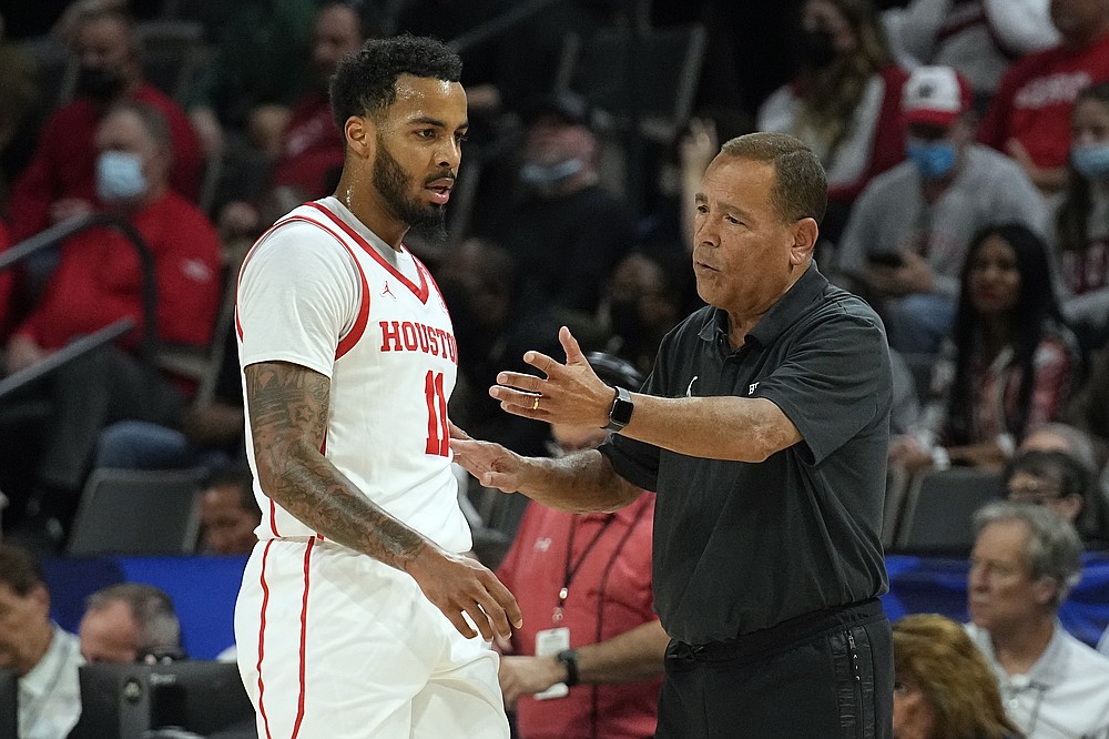 Houston head coach Kelvin Sampson talks to guard Kyler Edwards (11) in the first half during an NCAA college basketball game against Wisconsin at the Maui Invitational in Las Vegas, Tuesday, Nov. 23, 2021. (AP Photo/Rick Scuteri)