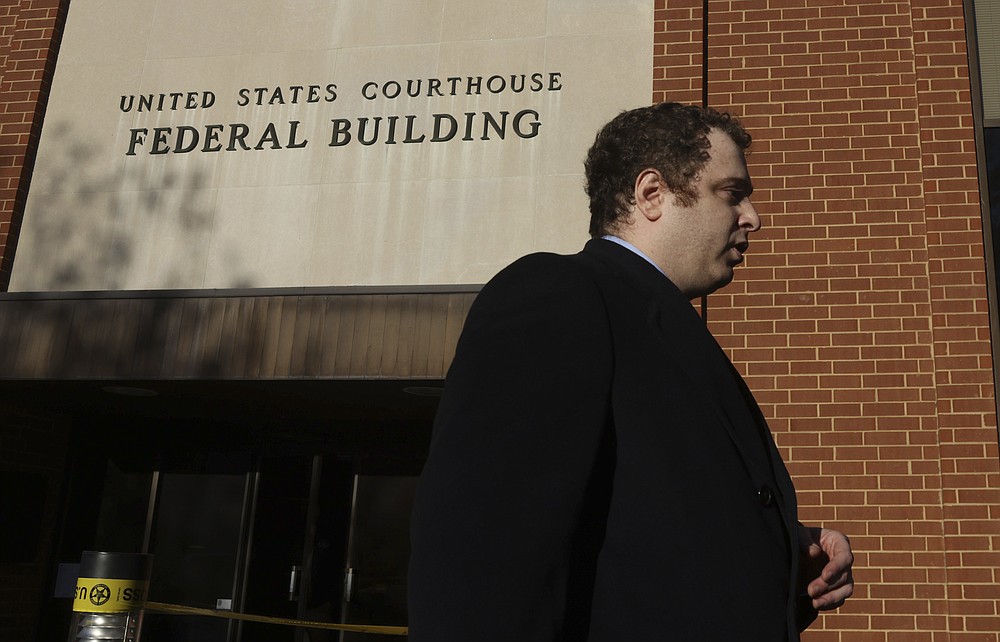 Josh Smith, attorney for Matthew Heimbach, Matthew Parrott and The Traditionalist Working Party, walks away after speaking with media after a jury gave a partial verdict in Sines v Kessler case Tuesday, Nov. 23, 2021, at the Federal Courthouse in Charlottesville, Va. A jury ordered white nationalist leaders and organizations to pay more than $25 million in damages Tuesday, Nov. 23, 2021, over violence that erupted during the deadly 2017 Unite the Right rally in Charlottesville. (Andrew Shurtleff/The Daily Progress via AP)
