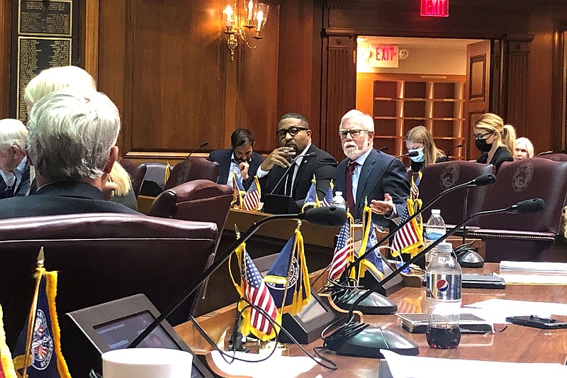 Indiana state Sen. Tim Lanane, D-Anderson, center, speaks during a state legislative hearing as Sen. Eddie Melton, D-Gary, left, watches Tuesday, Nov. 23, 2021, at the Indiana Statehouse in Indianapolis. Numerous Indiana medical and business groups argued against a Republican proposal aimed at ending the statewide COVID-19 public health emergency and forcing broad exemptions from workplace vaccination requirements. (AP Photo/Tom Davies)