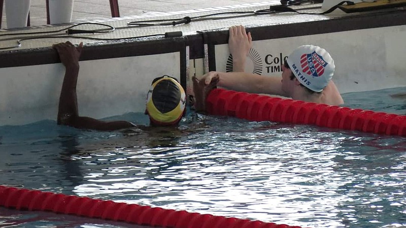 Submitted photo
Texarkana's Jeremiah Mathis shakes hands with a Ugandan swimmer after a competition in Belgrade, Serbia, earlier this year. Mathis was one of 11 U.S. swimmers to participate in the first U15 World School Sport Games.