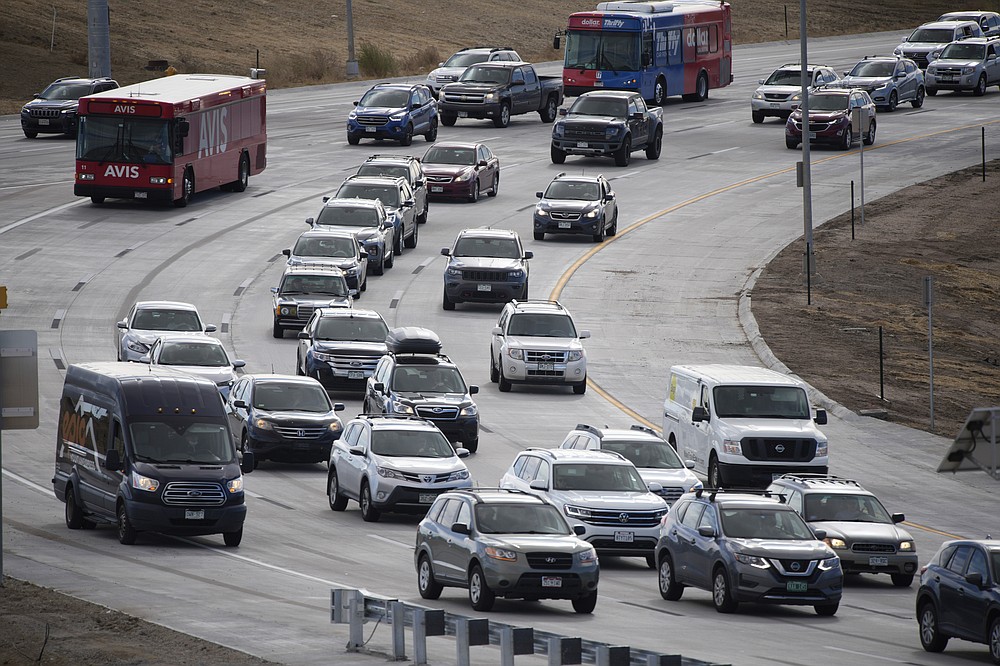 Motorists move slow on Pena Boulevard as traffic increases with the approach of the Thanksgiving Day holiday Tuesday, Nov. 23, 2021, at Denver International Airport in Denver. (AP Photo/David Zalubowski)