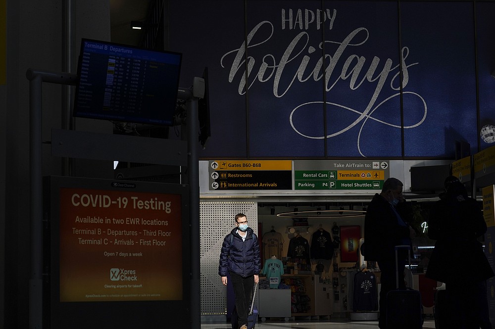 Holiday signs and decorations are displayed at Newark Liberty International Airport in Newark, N.J., Tuesday, Nov. 23, 2021. (AP Photo/Seth Wenig)