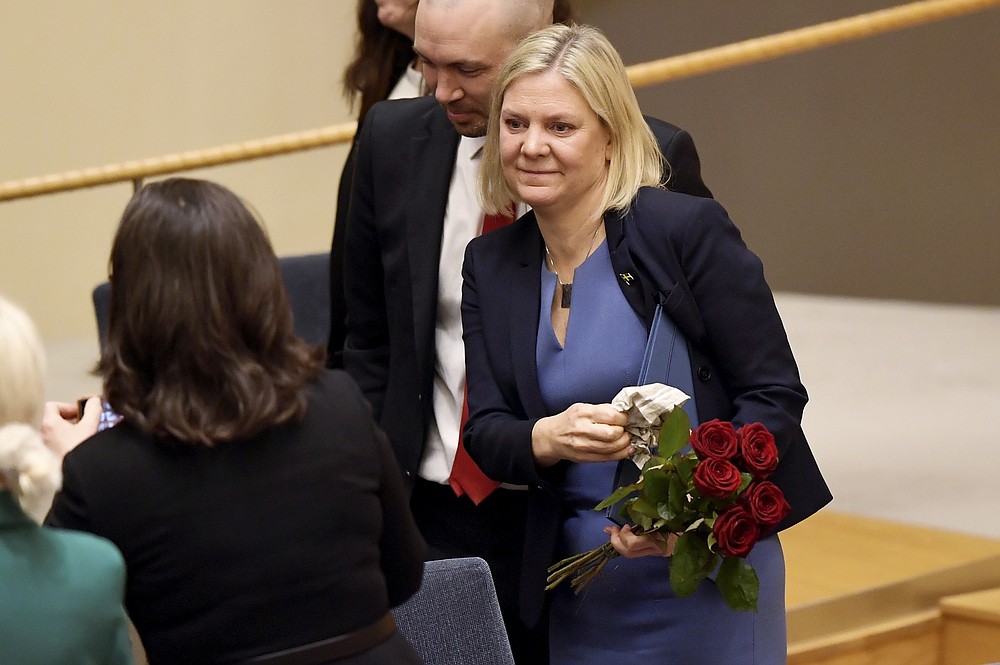 Sweden's Finance Minister and Scocial Democratic Party leader Magdalena Andersson holds flowers after a vote appointing her as Sweden's new prime minister, in the Swedish parliament Riksdagen, in Stockhom, Wednesday, Nov. 24, 2021. Sweden’s parliament has approved Magdalena Andersson as the country’s first female prime minister. Lawmakers on Wednesday tapped the finance minister who recently became the new leader of the Social Democratic party. Andersson was tapped to replace Stefan Lofven as party leader and prime minister, roles he relinquished earlier this year. (Erik Simander/TT News Agency via AP)