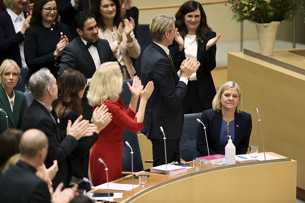 Lawmakers applaud after the vote in which Sweden's Finance Minister and Scocial Democratic Party leader Magdalena Andersson was appointed Sweden's new prime minister, in the Swedish parliament Riksdagen, in Stockhom, Wednesday, Nov. 24, 2021. Sweden’s parliament has approved Magdalena Andersson as the country’s first female prime minister. Lawmakers on Wednesday tapped the finance minister who recently became the new leader of the Social Democratic party. Andersson was tapped to replace Stefan Lofven as party leader and prime minister, roles he relinquished earlier this year. (Erik Simander/TT News Agency via AP)