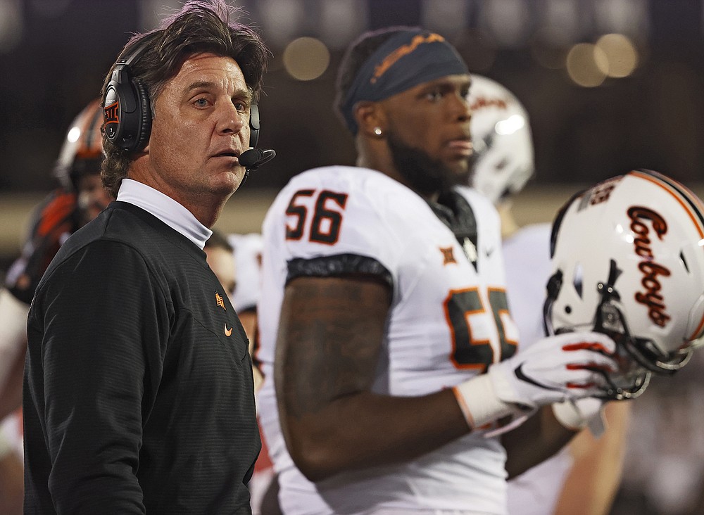 Oklahoma State coach Mike Gundy looks down the sideline during the second half of an NCAA college football game against Texas Tech, Saturday, Nov. 20, 2021, in Lubbock, Texas. (AP Photo/Brad Tollefson)