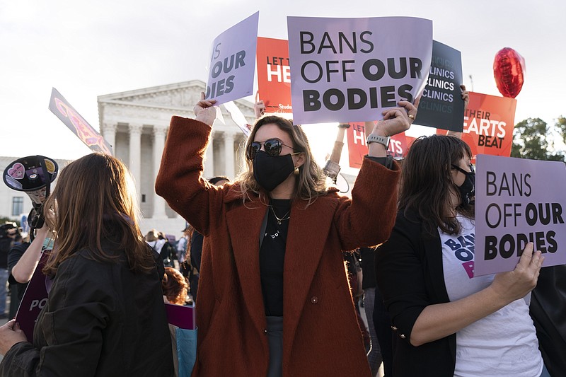 FILE - Emily Halvorson, center, of Washington, with Planned Parenthood, joins groups of abortion-rights and anti-abortion activists as they rally outside the Supreme Court, on, Nov. 1, 2021, as arguments are set to begin about abortion by the court, on Capitol Hill in Washington. U.S. abortions appear to be inching up after a long decline, though officials are cautious about calling it an upward trend because a government report issued Wednesday, Nov. 24, 2021, is incomplete. (AP Photo/Jacquelyn Martin, File)