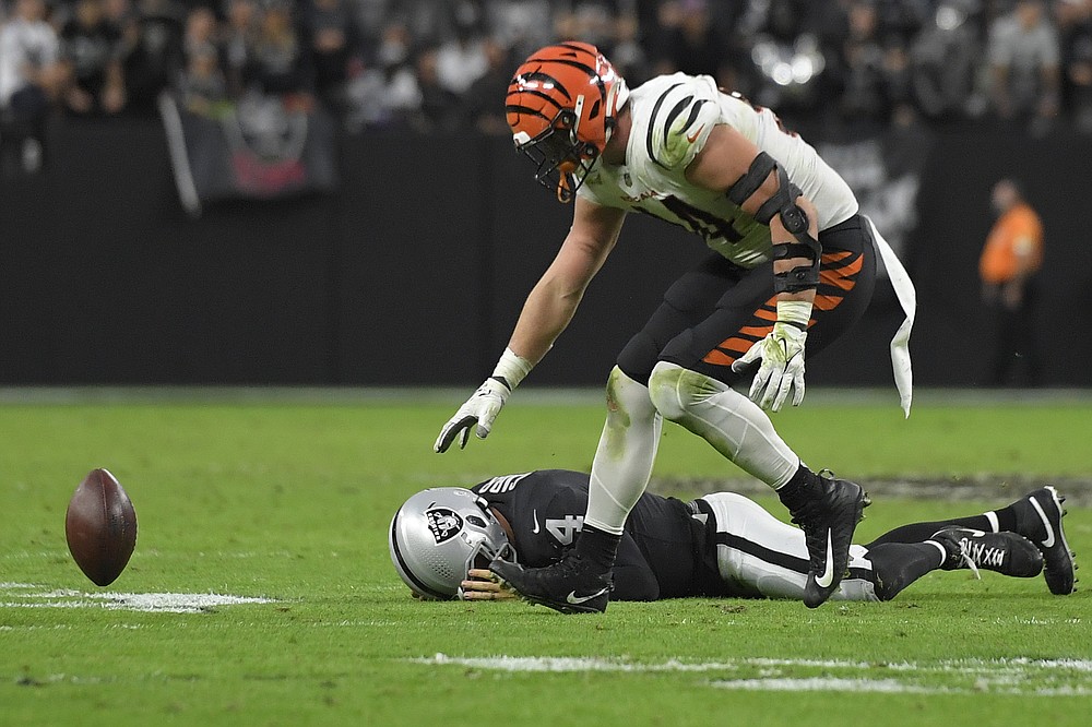 Cincinnati Bengals defensive end Sam Hubbard (94) recovers a fumble by Las Vegas Raiders quarterback Derek Carr (4) during the second half of an NFL football game, Sunday, Nov. 21, 2021, in Las Vegas. (AP Photo/David Becker)