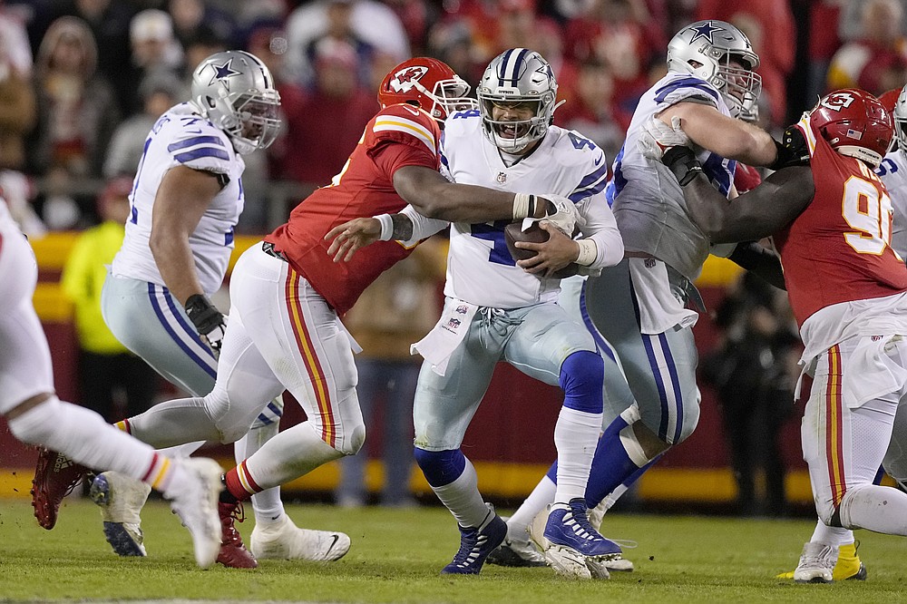 Dallas Cowboys quarterback Dak Prescott (4) is sacked by Kansas City Chiefs defensive tackle Chris Jones during the second half of an NFL football game Sunday, Nov. 21, 2021, in Kansas City, Mo. (AP Photo/Charlie Riedel)