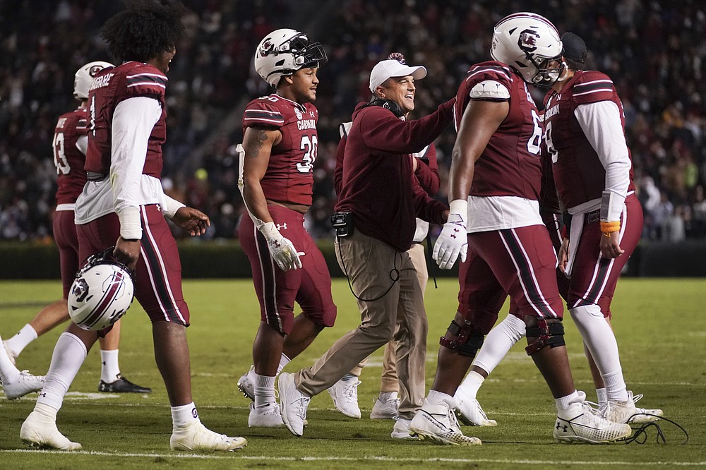 South Carolina coach Shane Beamer celebrates a play with Damani Staley (30) and Tyshawn Wannamaker, right, during the second half of the team's NCAA college football game against Florida on Saturday, Nov. 6, 2021, in Columbia, S.C. South Carolina won 40-17. (AP Photo/Sean Rayford)