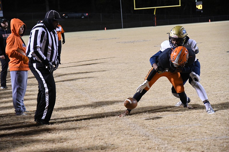 Marked Tree's Cameron Marshall (8) knocks the ball away from Magnet Cove's Brayden Campbell (22) in the Panthers' 34-16 second round win over the Indians. - Photo by Tanner Newton of The Sentinel-Record