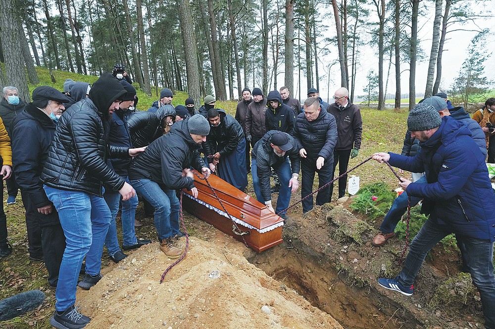 A local Muslim community buried a Yemeni migrant Mustafa Mohammed Murshed Al-Raimi, in Bohoniki, Poland, Sunday, Nov. 21, 2021. The person is one of about a dozen people from the Middle East and elsewhere who have died in a area of forests and bogs along the Poland-Belarus border amid a standoff involving migrants between the two countries. The burial took place in Muslim cemetery in Bohoniki, where a population of Muslim Tatars has lived for centuries. It was the second funeral which community members have performed for a migrant in the past week. (AP Photo/Czarek Sokolowski)