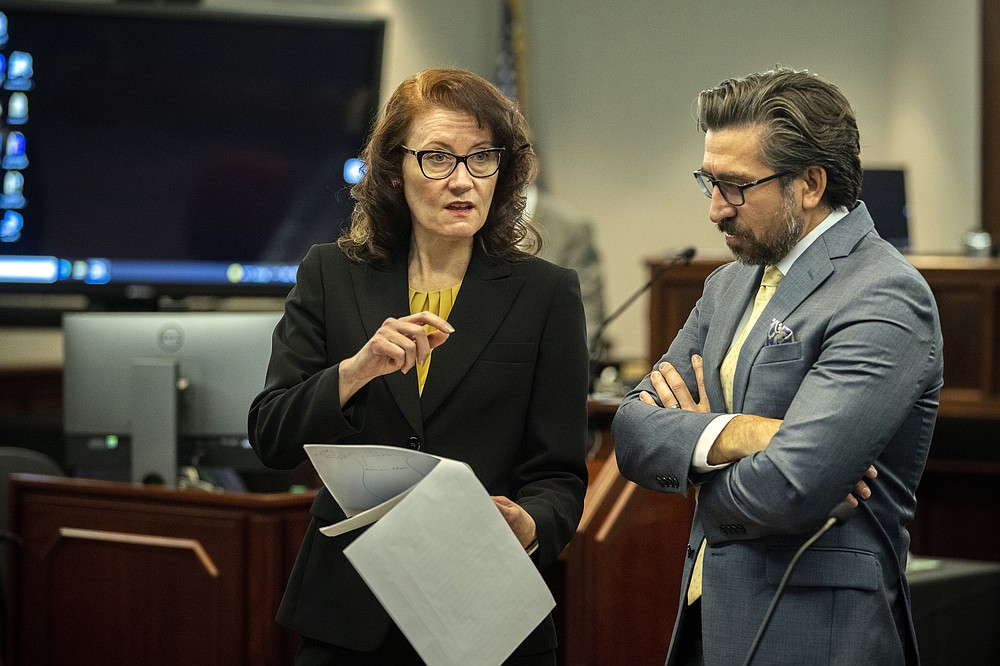 Prosecutors Linda Dunikoski, left, and Paul Camarillo, right, talk while the jury deliberates during the trial of Greg McMichael and his son, Travis McMichael, and a neighbor, William "Roddie" Bryan in the Glynn County Courthouse, Wednesday, Nov. 24, 2021, in Brunswick, Ga. The three are charged with the February 2020 slaying of 25-year-old Ahmaud Arbery. (AP Photo/Stephen B. Morton, Pool)