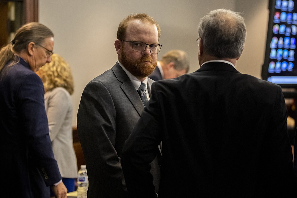 Travis McMichael looks back at his mother and sister in the courtroom after the jury convicted him for the murder of Ahmaud Arbery in the Glynn County Courthouse, Wednesday, Nov. 24, 2021, in Brunswick, Ga. Greg McMichael and his son, Travis and a neighbor, William "Roddie" Bryan, charged in the death of Ahmaud Arbery were convicted of murder Wednesday in the fatal shooting that became part of a larger national reckoning on racial injustice.(AP Photo/Stephen B. Morton, Pool)