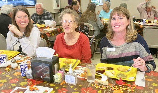 Westside Eagle Observer/SUSAN HOLLAND
Paulee Hendren (left) enjoys Thanksgiving dinner with her grandmother, Lana Dunnaway, and her mother, Sundee Hendren. The three generations were among several families who came out for Thanksgiving dinner at the Billy V. Hall Senior Activity Center Thursday, Nov. 18. The day also featured a watercolor class and drawings for a quilt raffle and secret Santa participants.