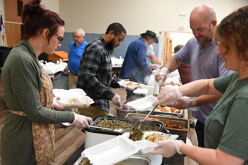 Volunteers at Grand Avenue United Methodist Church prepare Thanksgiving meals on Thursday.  - Photo by Tanner Newton of The Sentinel-Record