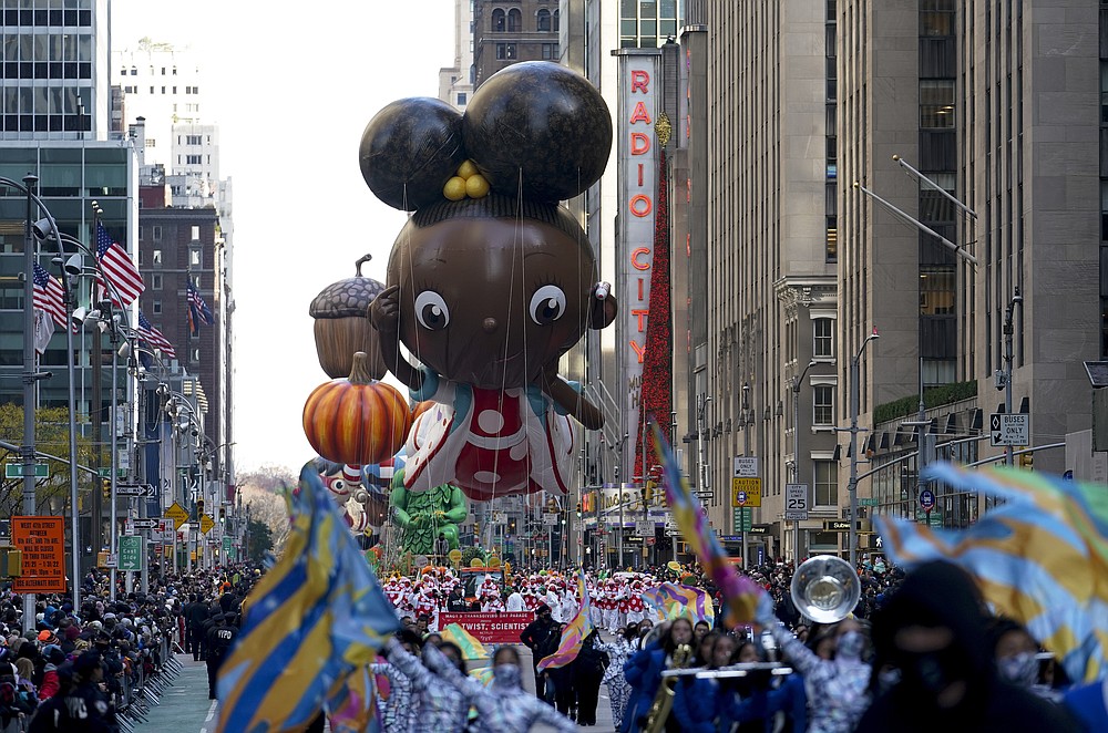 The Ada Twist balloon moves down Sixth Avenue during the Macy's Thanksgiving Day Parade in New York, Thursday, Nov. 25, 2021. The parade is returning in full, after being crimped by the coronavirus pandemic last year. (AP Photo/Jeenah Moon)