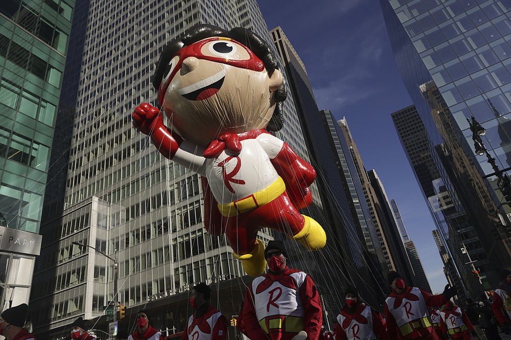 The Red Titan ballon makes its way down Sixth Avenue during the Macy's Thanksgiving Day Parade, Thursday, Nov. 25, 2021, in New York. The Macy's Thanksgiving Day Parade is returning in full, after being crimped by the coronavirus pandemic last year. The Thanksgiving parade is the latest U.S. holiday event to make a comeback amid the ongoing pandemic. (AP Photo/Jeenah Moon)