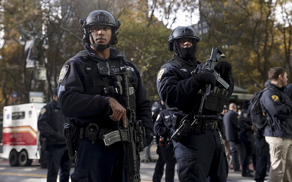 New York Police special operations officers stand watch during the Macy's Thanksgiving Day Parade, Thursday, Nov. 25, 2021, in New York. The Macy's Thanksgiving Day Parade is returning in full, after being crimped by the coronavirus pandemic last year. (AP Photo/Jeenah Moon)