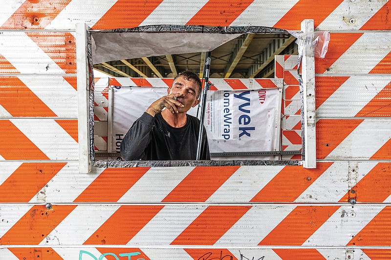 Homeless man builds cabin from campaign signs and barricades in