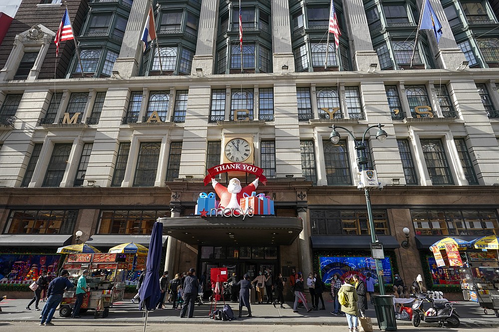 FILE Black Friday shoppers walk past Macy's flagship store, Friday, Nov. 27, 2020, in New York's Herald Square. Retailers are expected to usher in the unofficial start to the holiday shopping season Friday, Nov. 26, 2021, with bigger crowds than last year in a closer step toward normalcy. But the fallout from the pandemic continues to weigh on businesses and shoppers' minds. (AP Photo/Mary Altaffer, File)
