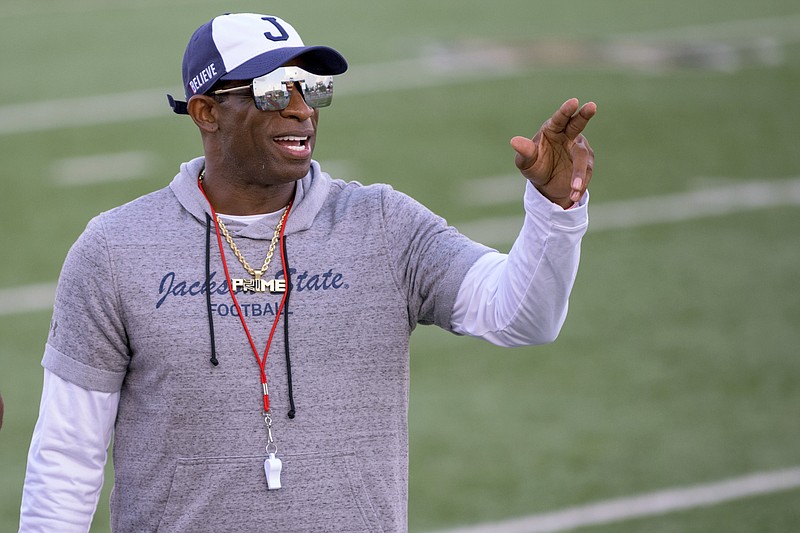 Jackson State head coach Deion Sanders points during a game against Louisiana Monroe on Sept. 18, in Monroe, La. Sanders has been all over national TV, putting Jackson State in the spotlight every time his insurance commercials air. Hiring Eddie George has had a similar effect at Tennessee State. - Photo by Matthew Hinton of The Associated Press