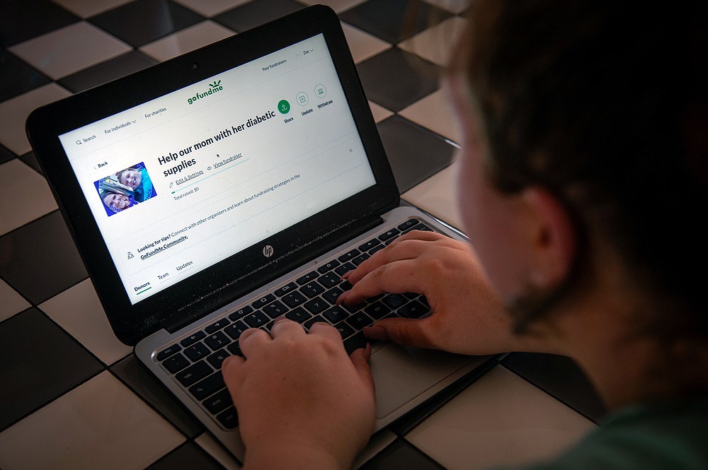 Zoe Massery shows the GoFundMe page she set up for her mother in Ward on Aug. 12. - Photo by Rory Doyle