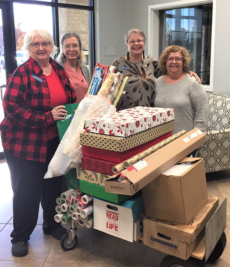 The Altrusa Club of Bentonville/Bella Vista went to the Single Parent Scholarship Fund office on Nov. 16 to deliver wrapping paper, children's books and a $500 donation for the SPFS Festival of Giving project. Pictured are club members Sue McEvoy and Sue Sterling, club president Connie Brown and Barb Smith of Altrusa of Rogers.

(Courtesy photo)