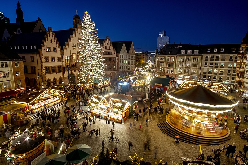 Lights illuminate the Christmas market in Frankfurt, Germany, on Nov. 22. Despite the pandemic inconveniences, stall owners selling ornaments, roasted chestnuts and other holiday-themed items in Frankfurt and other European cities are relieved to be open at all for their first Christmas market in two years, especially with new restrictions taking effect in Germany, Austria and other countries as COVID-19 infections hit record highs. - AP Photo/Michael Probst