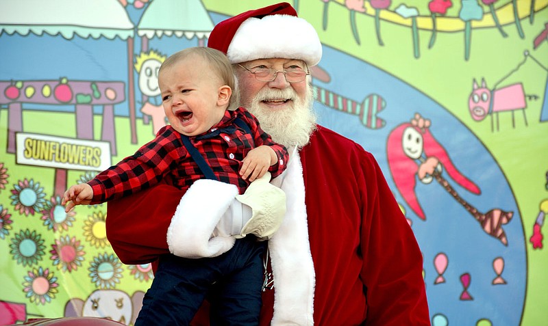 File photo Benjamin Goggans (left) had a memorable first experience with Santa. For his part, Santa loves all kids, even the ones who cry when they see him.