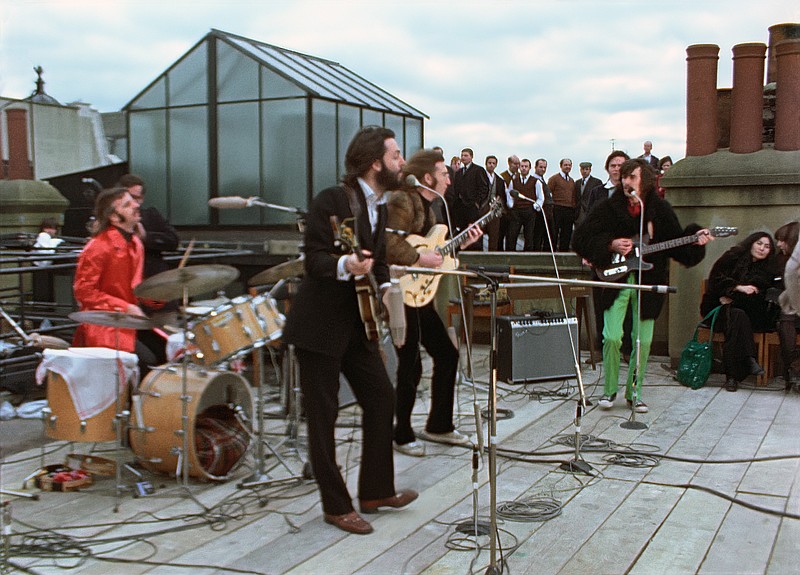 This image released by Disney+ shows, from left, Ringo Starr, Paul McCartney, John Lennon and George Harrison, with Yoko Ono, seated right, in a scene from the nearly 8-hour Peter Jackson-produced documentary “Get Back,” airing over three days starting Thanksgiving. - Disney+ via AP