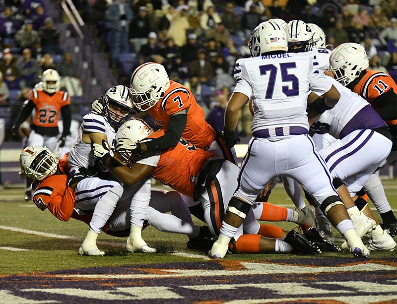 A trio of Texas High Tigers work together to bring down a Port Neches-Grove ball carrier during a Class 5A, Division II regional semifinal Friday, Nov. 26, 2021, at Harry Turpin Stadium on the campus of Northwestern State University in Natchitoches, La. (Photo by Kevin Sutton)