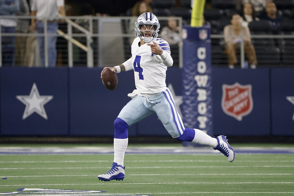 Dallas Cowboys quarterback Dak Prescott (4) scrambles before