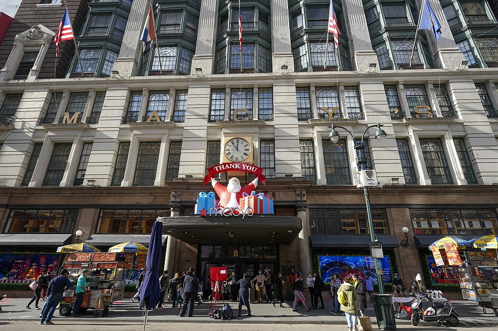 FILE Black Friday shoppers walk past Macy&#x27;s flagship store, Friday, Nov. 27, 2020, in New York&#x27;s Herald Square. Retailers are expected to usher in the unofficial start to the holiday shopping season Friday, Nov. 26, 2021, with bigger crowds than last year in a closer step toward normalcy. But the fallout from the pandemic continues to weigh on businesses and shoppers&#x27; minds. (AP Photo/Mary Altaffer, File)