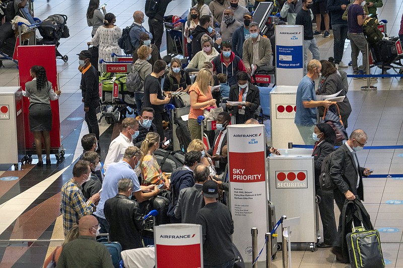 The Associated Press
People line up to get on the Air France flight to Paris at OR Tambo International Airport in Johannesburg, South Africa, on Friday.