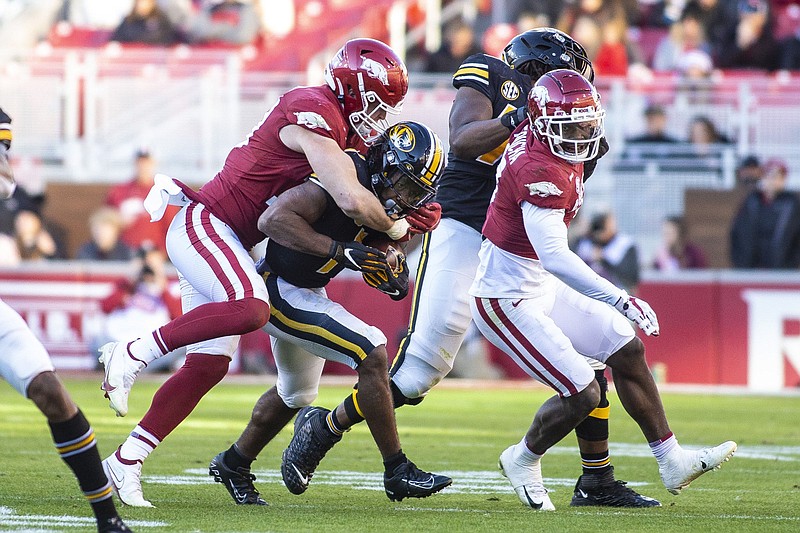 Arkansas Linebacker Bumper Pool (10) making the tackle on Missouri Running Back Tyler Badie (1) on Friday, Nov. 26 2021, during the first half of play at Reynolds Razorback Stadium, Fayetteville. Visit nwaonline.com/211027Daily/ for today's photo gallery.
(Special to the NWA Democrat-Gazette/David Beach)