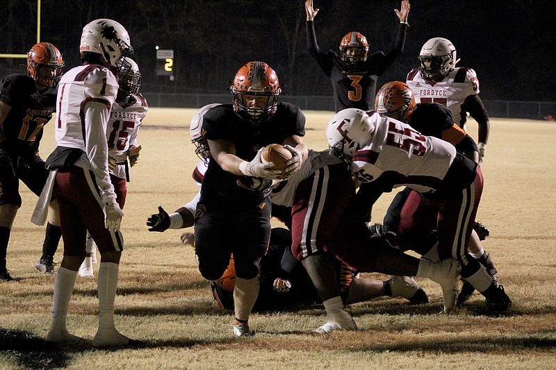 Magnet Cove’s Brett Williams (33) carries the ball in for a touchdown as quarterback Jacob Clausen (3) signals the score in the first quarter of Friday’s game against Fordyce at Kenneth W. Hammons Stadium. The Redbugs rallied from a 15-0 deficit to defeat the Panthers 30-29 and advance to next week's semifinal round of the Class 3A state football playoffs. - Photo by James Leigh of The Sentinel-Record