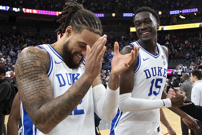 Duke forward Theo John, left, and center Mark Williams celebrate after the team's win over Gonzaga in an NCAA basketball game Friday in Las Vegas. - Photo by Ellen Schmidt of The Associated Press