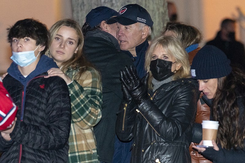 President Joe Biden is hugged by his son Hunter Biden as they attend the annual Christmas Tree Lighting ceremony with first lady Jill Biden and family, Friday, Nov. 26, 2021,  in Nantucket, Mass. (AP Photo/Carolyn Kaster)