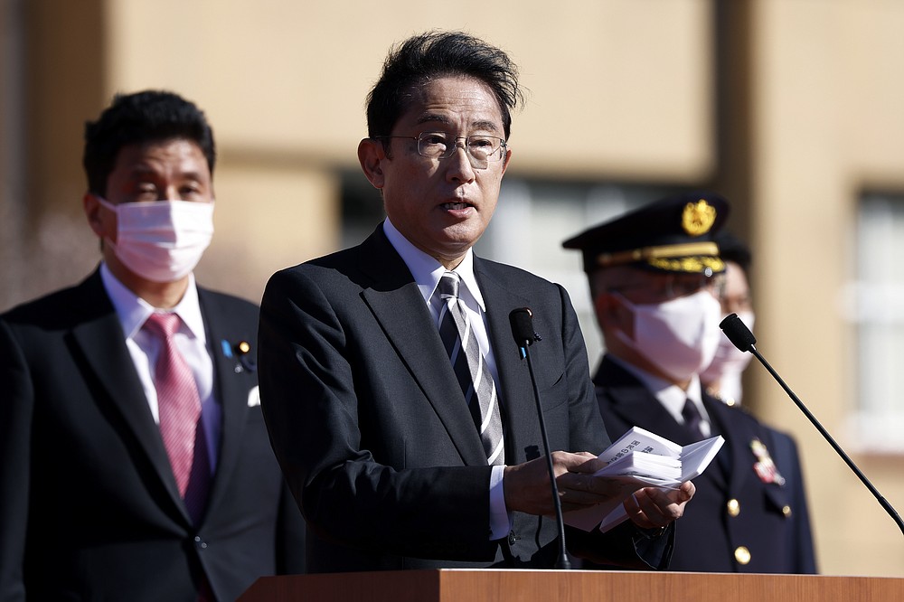 Japan&#x27;s Prime Minister Fumio Kishida, center, speaks in front of troops of the Japan Self-Defense Forces during a review at the Japan Ground Self-Defense Force Camp Asaka in Tokyo, Japan, Saturday, Nov. 27, 2021. Kishida, at his first troop review Saturday, renewed his pledge to consider &amp;#x201c;all options,&amp;#x201d; including acquiring enemy base strike capability, and vowed to create a stronger Self-Defense Force to protect the country amid growing threats from China and North Korea. (Kiyoshi Ota/Pool Photo via AP)