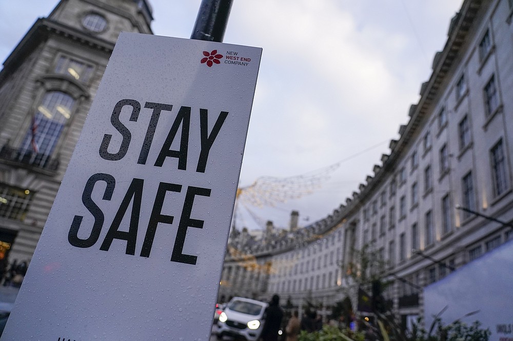 A sign reading 'Stay safe' in Regent Street, in London, Friday, Nov. 26, 2021. A slew of nations moved to stop air travel from southern Africa on Friday, and stocks plunged in Asia and Europe in reaction to news of a new, potentially more transmissible COVID-19 variant. (AP Photo/Alberto Pezzali)